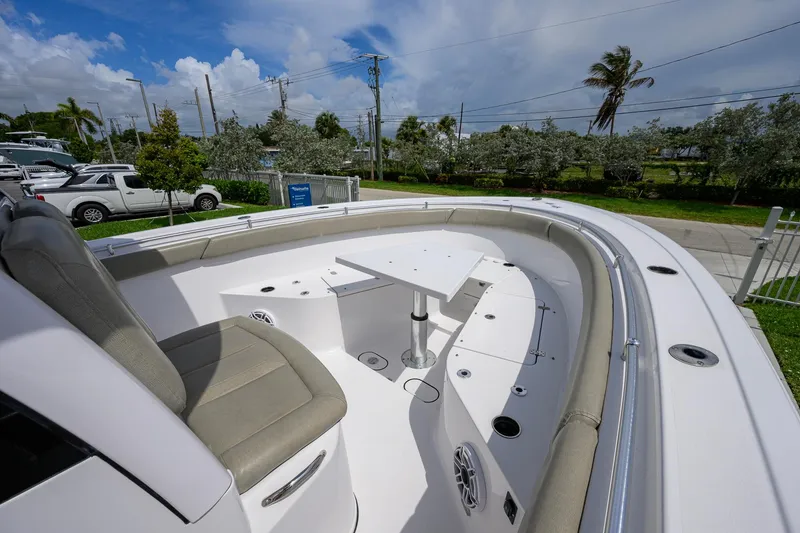 Slide: The Image of 2023 Sportsman Open 302 Center Console boat interior with seating and table. - 15
