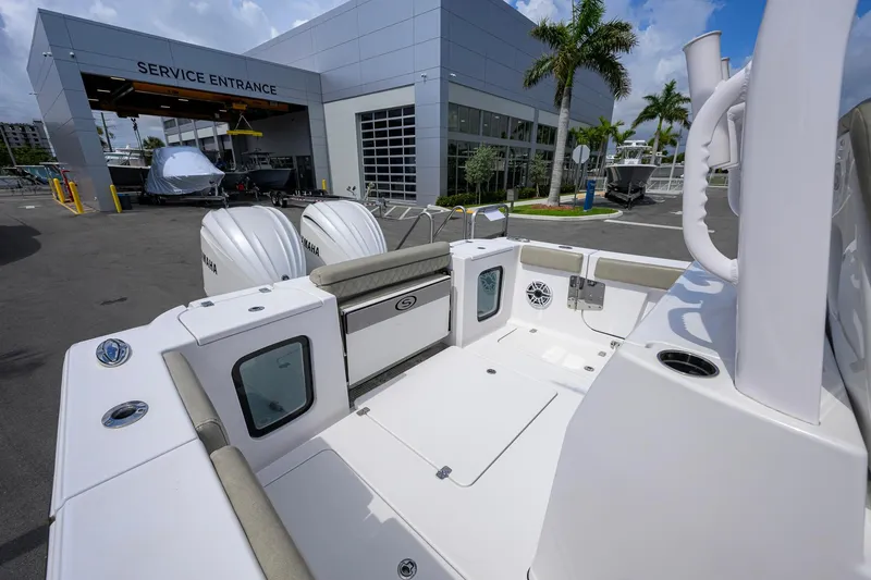 Slide: The Image of 2023 Sportsman Open 302 Center Console boat at service entrance with twin Yamaha engines. - 18