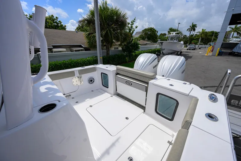 Slide: The Image of 2023 Sportsman Open 302 Center Console boat with Yamaha engines, docked outdoors. - 20