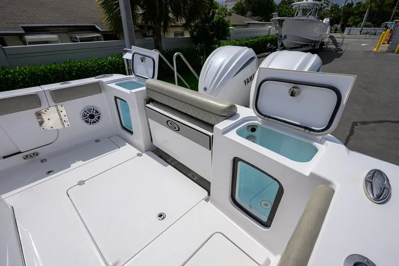 Slide: The Image of 2023 Sportsman Open 302 Center Console boat interior with storage compartments and Yamaha engines. - 21