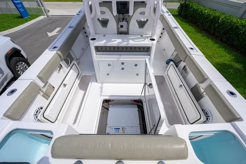 Slide: The Image of 2023 Sportsman Open 302 Center Console boat interior with storage compartments open. - 26