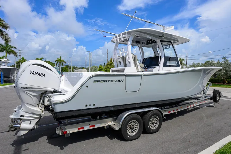 Slide: The Image of 2023 Sportsman Open 302 Center Console boat on trailer, featuring Yamaha engine. - 3