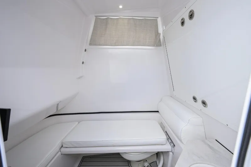 Slide: The Image of 2023 Sportsman Open 302 Center Console cabin interior with cushioned seating and modern design. - 32