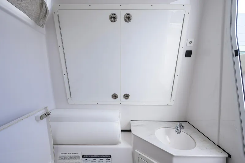 Slide: The Image of 2023 Sportsman Open 302 Center Console interior with sink and storage compartment. - 33