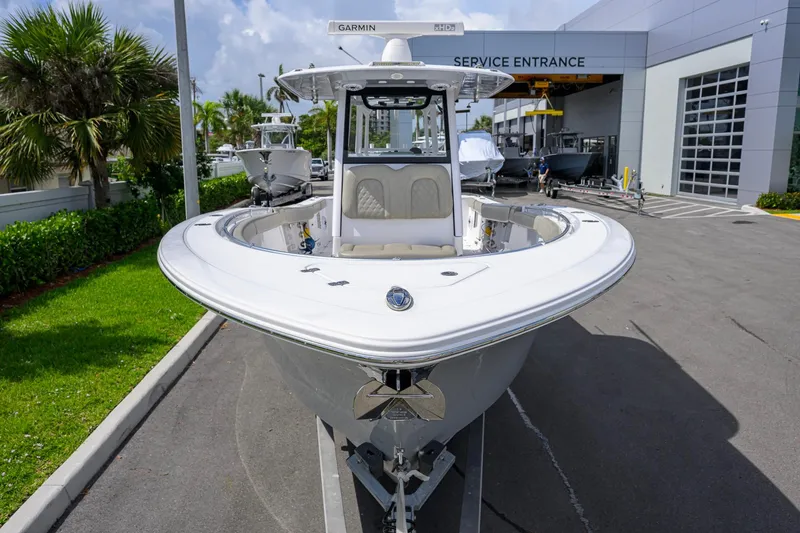 Slide: The Image of 2023 Sportsman Open 302 Center Console boat at service entrance, sunny day. - 5