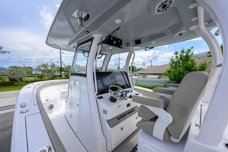 Slide: The Image of 2023 Sportsman Open 302 Center Console boat interior with helm and seating. - 7