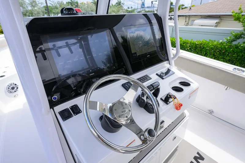 Slide: The Image of 2023 Sportsman Open 302 Center Console helm with dual displays and steering wheel. - 8