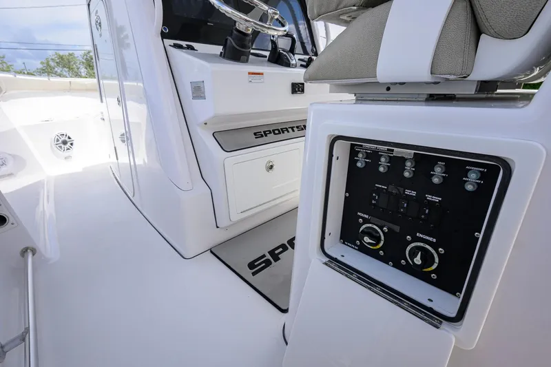Slide: The Image of 2023 Sportsman Open 302 Center Console interior with control panel and steering wheel. - 9