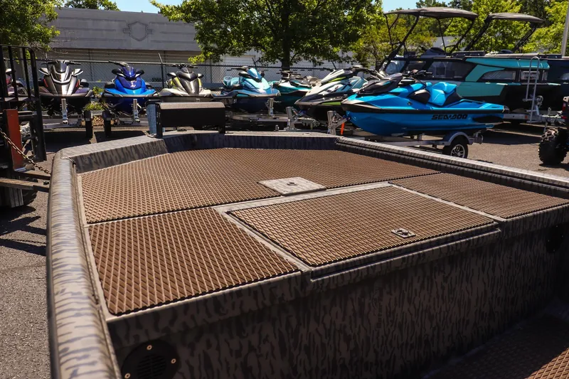 Slide: The Image of 2026 Gator Tail 18/60 Extreme Series boat in a showroom with jet skis. - 10