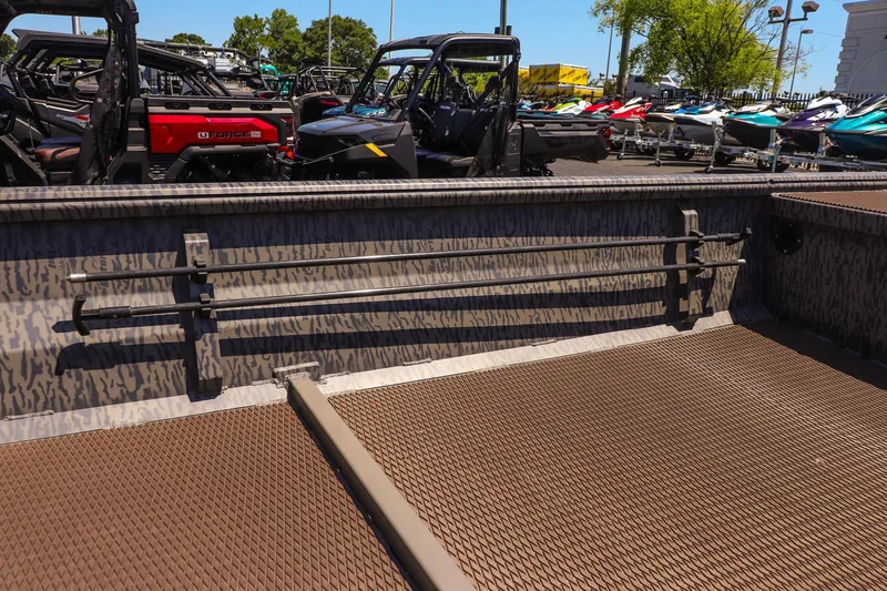 Slide: The Image of 2026 Gator Tail 18/60 Extreme Series boat interior with textured flooring and rod holders. - 13