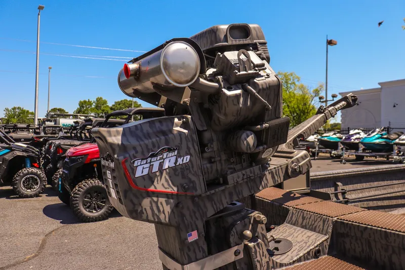 Slide: The Image of 2026 Gator Tail 18/60 Extreme Series boat motor in outdoor showroom. - 14