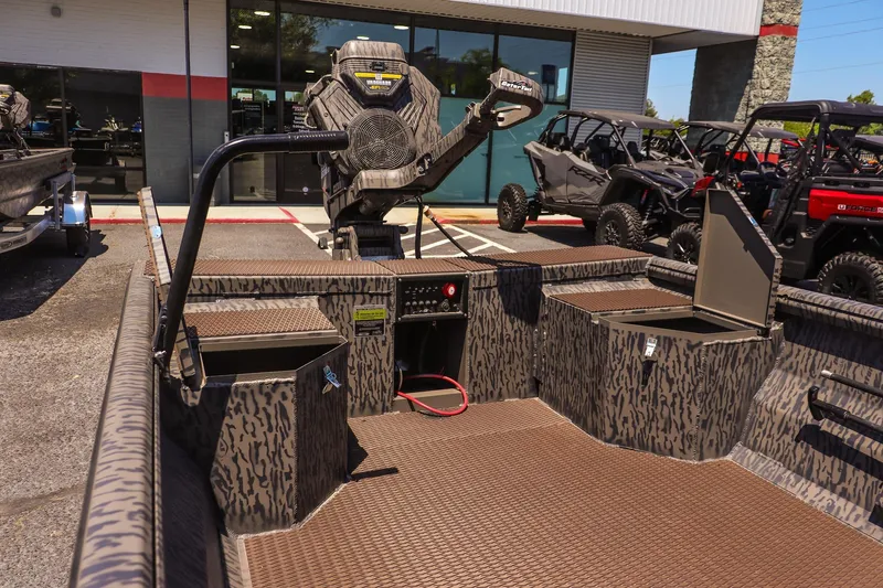 Slide: The Image of 2026 Gator Tail 18/60 Extreme Series boat interior with camo design and storage compartments. - 16