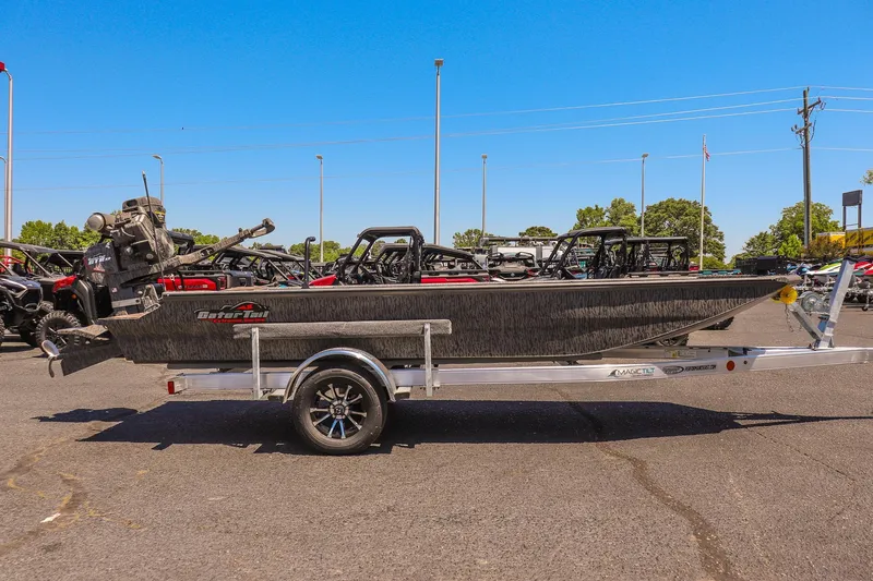 Slide: The Image of 2026 Gator Tail 18/60 Extreme Series boat on trailer, parked outdoors under clear blue sky. - 2