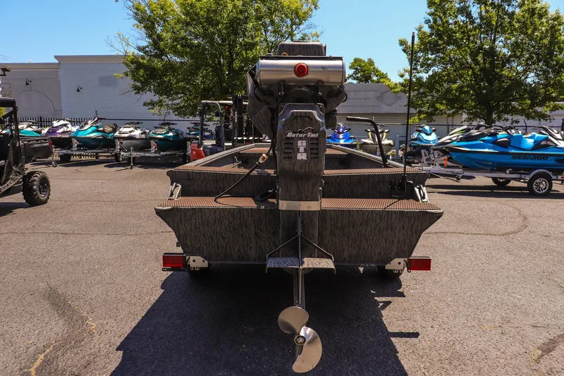 Slide: The Image of 2026 Gator Tail 18/60 Extreme Series boat with motor, parked outdoors. - 4
