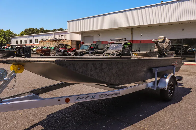 Slide: The Image of 2026 Gator Tail 18/60 Extreme Series boat on trailer outside dealership. - 6