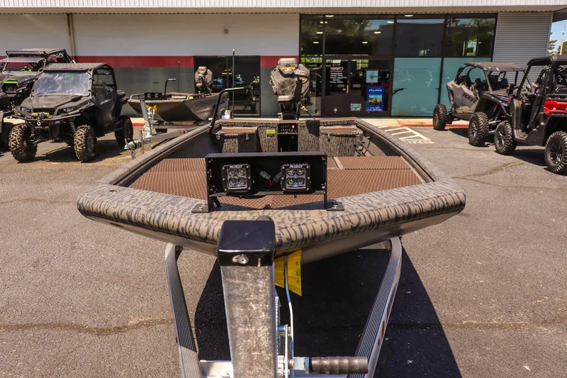 Slide: The Image of 2026 Gator Tail 18/60 Extreme Series boat displayed outdoors at dealership. - 7