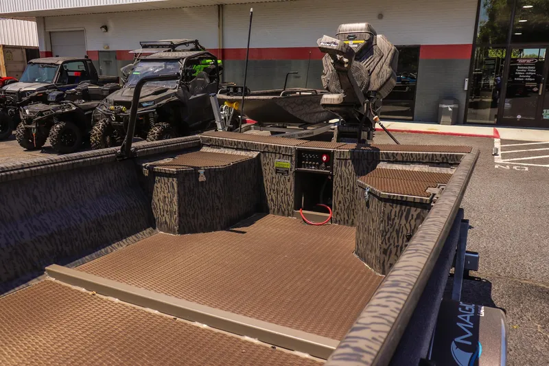 Slide: The Image of 2026 Gator Tail 18/60 Extreme Series boat interior with camo design and motor. - 9