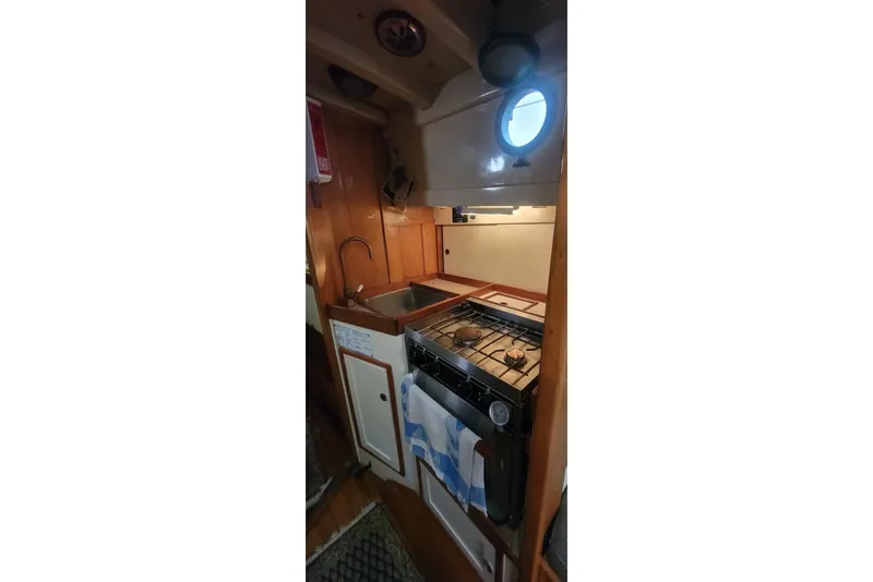 Slide: The Image of 1936 Freeman 37 boat kitchen with stove, sink, and wooden cabinetry. - 10