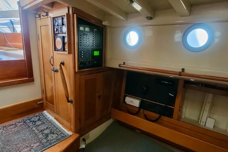 Slide: The Image of Interior of a 1936 Freeman 37 boat with wooden cabinetry and control panel. - 13