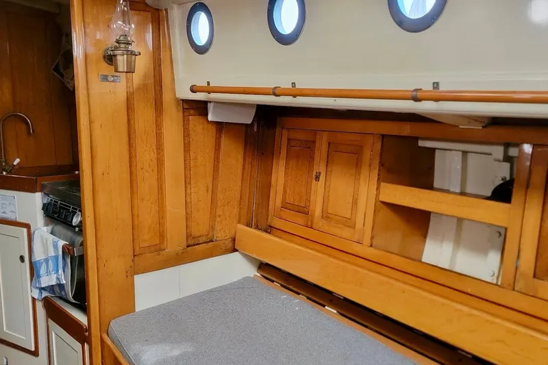 Slide: The Image of Interior of a 1936 Freeman 37 boat with wooden cabinetry and portholes. - 14
