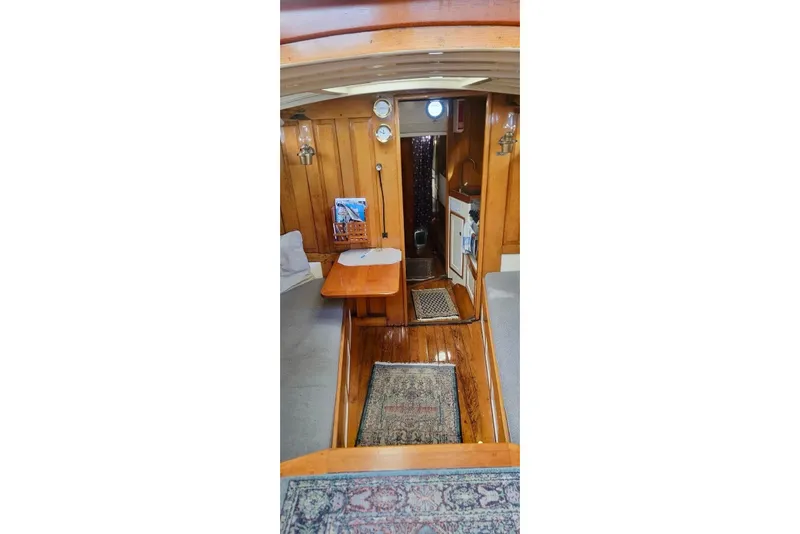 Slide: The Image of Interior of a 1936 Freeman 37 boat with wooden paneling and nautical decor. - 15