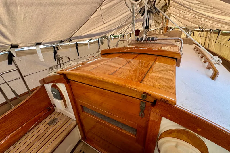 Slide: The Image of Wooden deck and cabin of a 1936 Freeman 37 sailboat under a protective cover. - 4