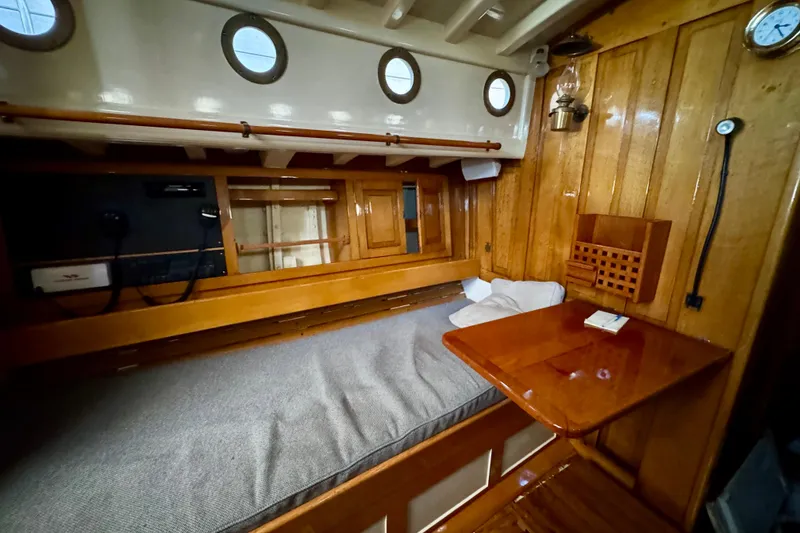 Slide: The Image of Cozy 1936 Freeman 37 boat cabin with wooden interior and portholes. - 5