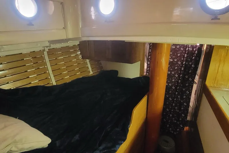 Slide: The Image of Cozy cabin interior of a 1936 Freeman 37 boat with wooden accents and portholes. - 6