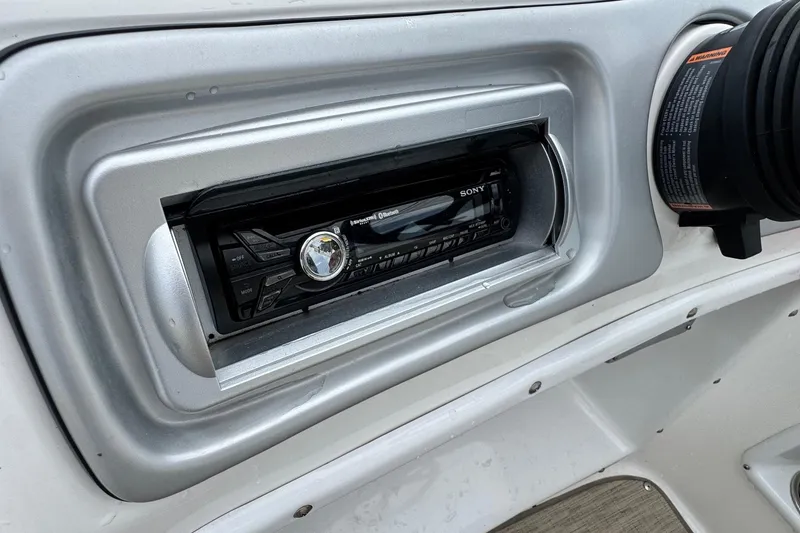 Slide: The Image of 2014 Hurricane SunDeck Sport 203 OB boat dashboard with Sony stereo system. - 12
