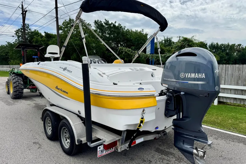 Slide: The Image of 2014 Hurricane SunDeck Sport 203 OB boat with Yamaha outboard motor on trailer. - 2