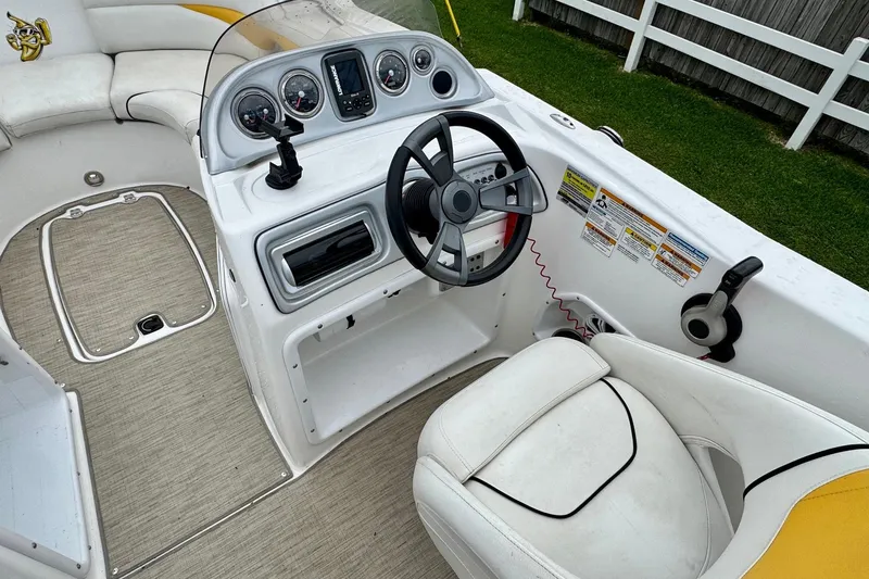 Slide: The Image of 2014 Hurricane SunDeck Sport 203 OB boat interior with steering wheel and dashboard controls. - 8