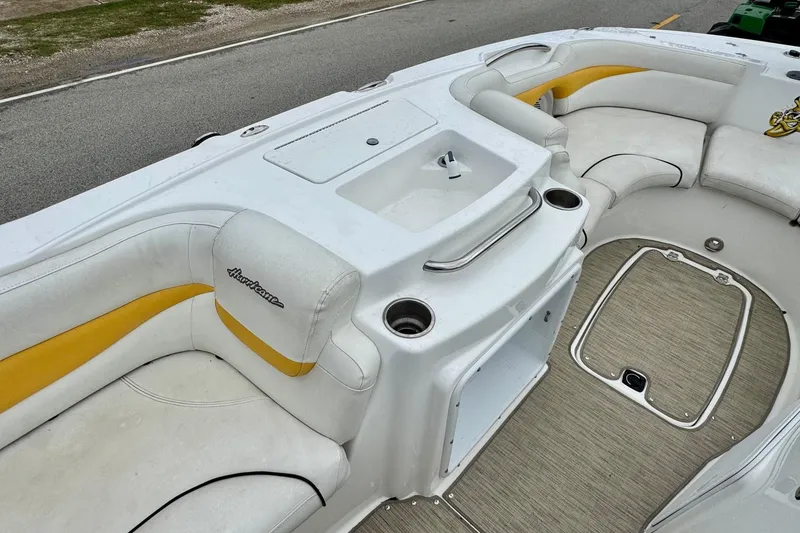 Slide: The Image of 2014 Hurricane SunDeck Sport 203 OB boat interior with white and yellow seating. - 9