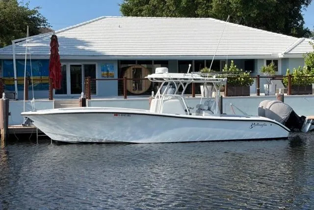 The Image of 2019 Yellowfin 32 Offshore boat docked by a waterfront house. - 0
