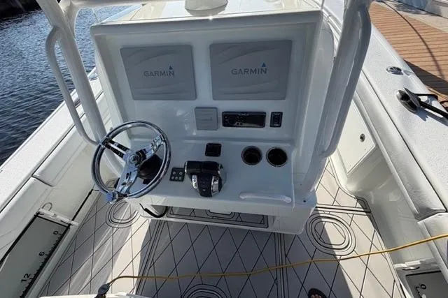 Slide: The Image of 2019 Yellowfin 32 Offshore boat helm with Garmin displays and steering wheel. - 1