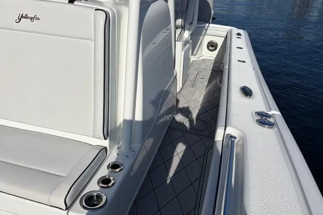 Slide: The Image of 2019 Yellowfin 32 Offshore boat deck with seating and cup holders. - 13