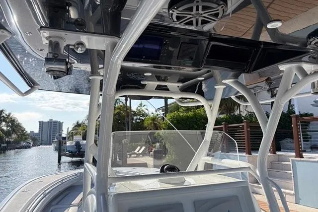 Slide: The Image of 2019 Yellowfin 32 Offshore boat interior with modern controls and waterfront view. - 15