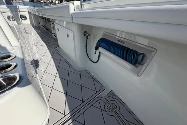 Slide: The Image of 2019 Yellowfin 32 Offshore boat deck with hose storage and sleek design. - 8