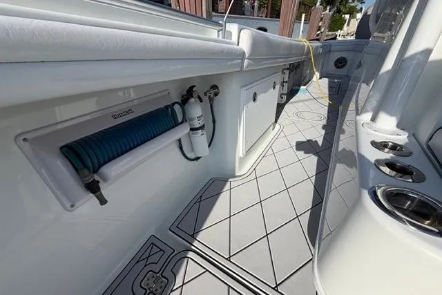 Slide: The Image of 2019 Yellowfin 32 Offshore boat deck with storage compartments and hose reel. - 9