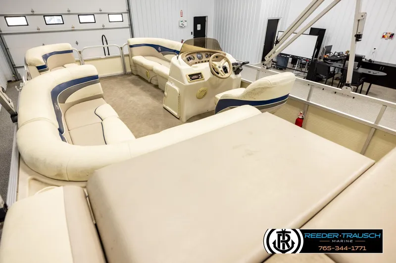 Slide: The Image of Interior of a 2008 Sedona 20 CR pontoon boat with beige seating and steering console. - 11
