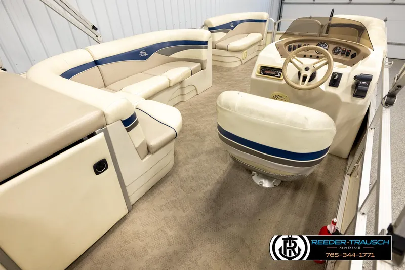 Slide: The Image of Interior of a 2008 Sedona 20 CR pontoon boat with beige seating and steering console. - 12