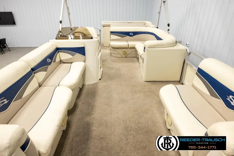 Slide: The Image of 2008 Sedona 20 CR pontoon boat interior with beige and blue seating. - 13
