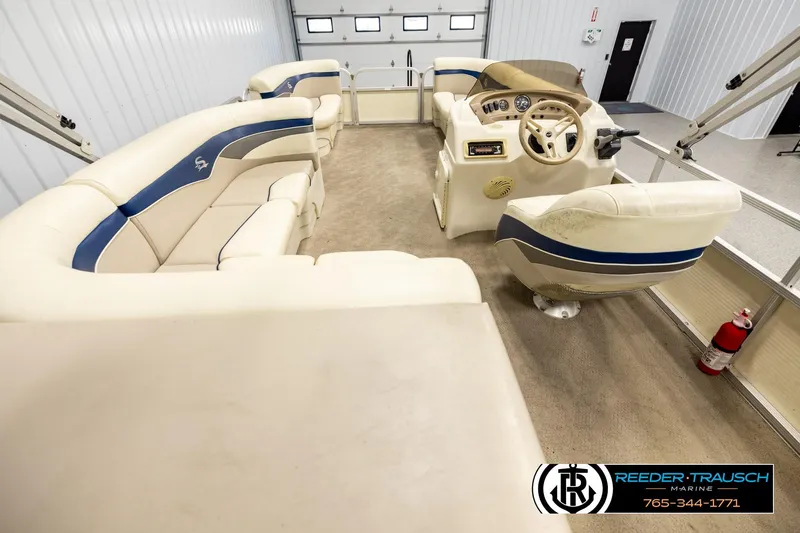 Slide: The Image of Interior of a 2008 Sedona 20 CR pontoon boat with beige seating and steering console. - 16