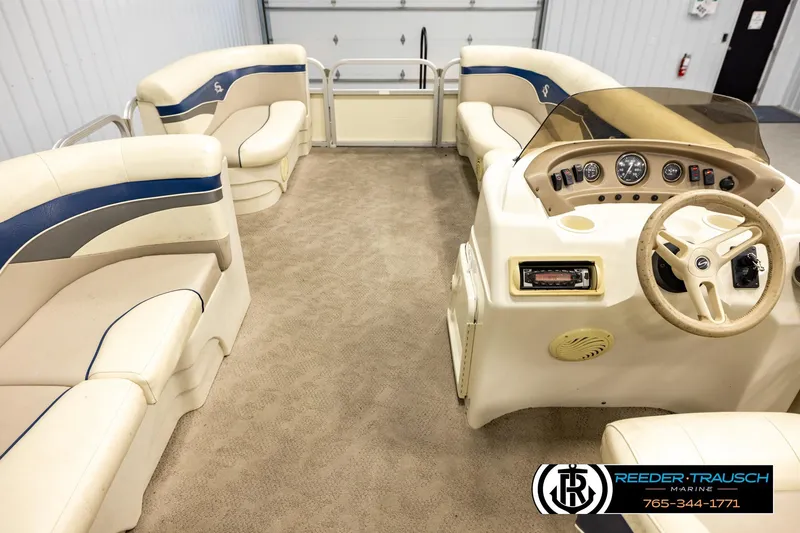 Slide: The Image of Interior of a 2008 Sedona 20 CR pontoon boat with beige seating and steering console. - 17