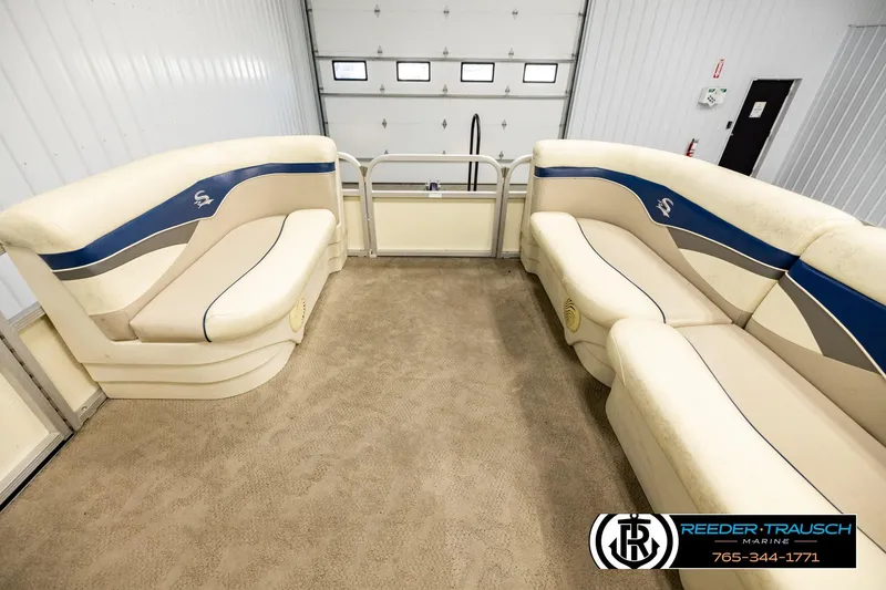 Slide: The Image of Interior of a 2008 Sedona 20 CR pontoon boat with beige and blue seating. - 18
