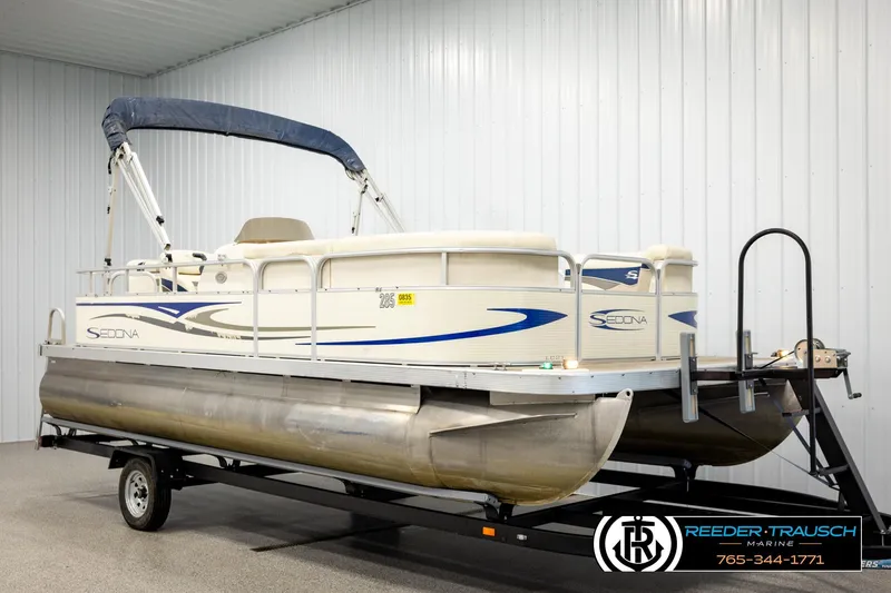 Slide: The Image of 2008 Sedona 20 CR pontoon boat on trailer in indoor storage. - 2