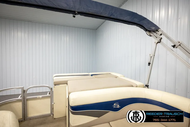 Slide: The Image of 2008 Sedona 20 CR pontoon boat interior with blue and beige seating in storage. - 22