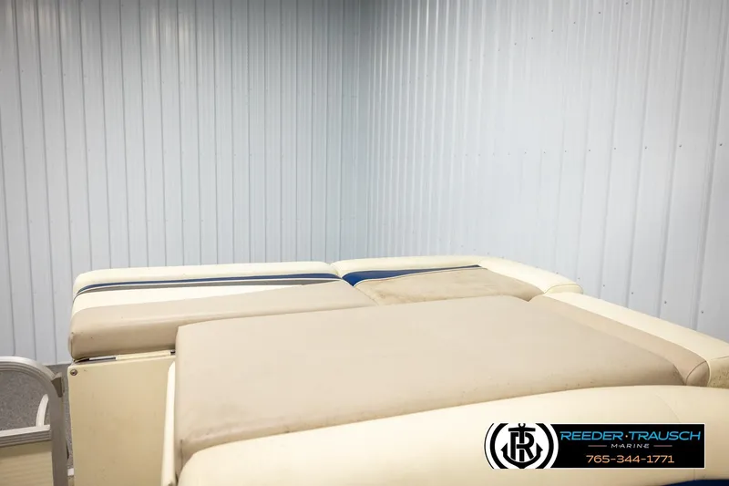 Slide: The Image of 2008 Sedona 20 CR boat interior with cushioned seating in a metal-walled room. - 24