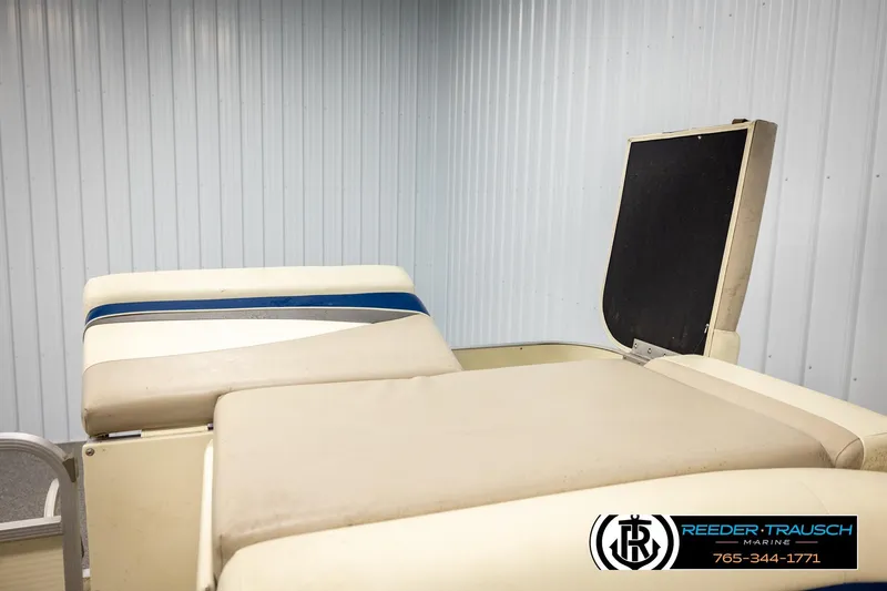 Slide: The Image of 2008 Sedona 20 CR boat seating with beige upholstery and blue accent in a metal-walled room. - 25