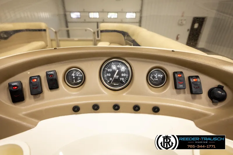 Slide: The Image of 2008 Sedona 20 CR boat dashboard with gauges and control switches. - 30
