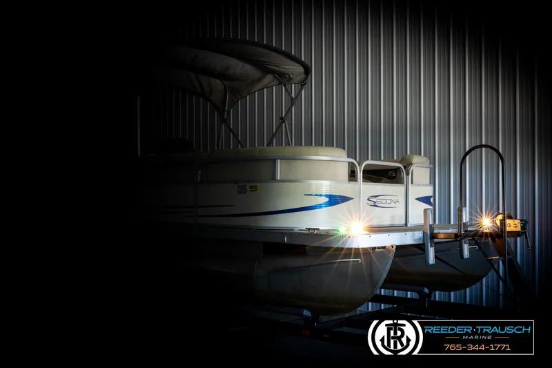 Slide: The Image of 2008 Sedona 20 CR pontoon boat in a dimly lit storage area. - 4